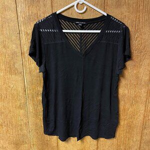 Soft black v neck short sleeve with sheer pattern detail at shoulders